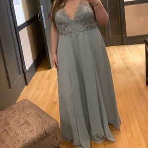 Is a size 18w blue from David’s bridal low cut in front lace top with slit